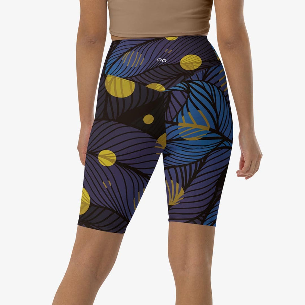 Close-up of white biker shorts with abstract print, back view.