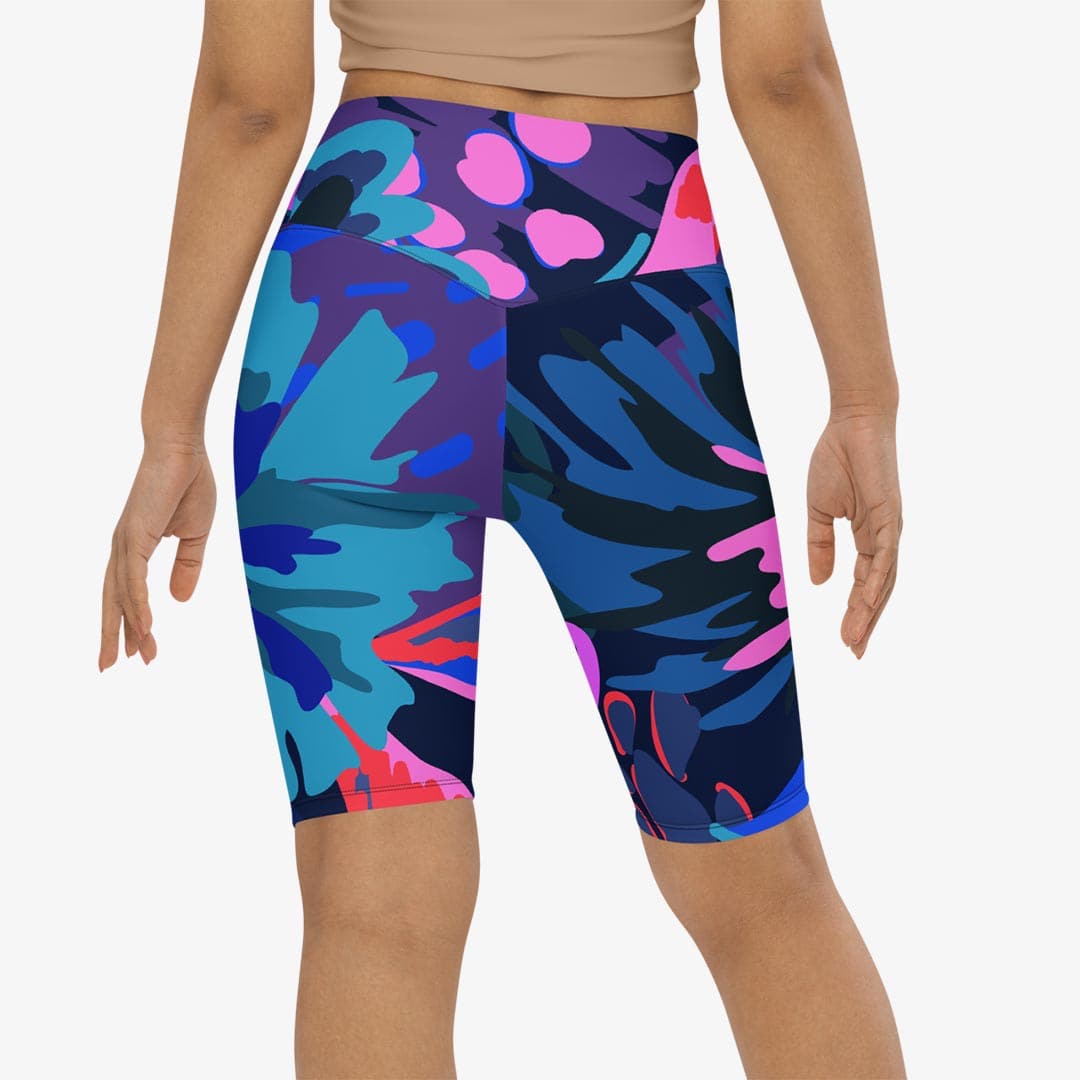 Close-up of white biker shorts with abstract print, back view.
