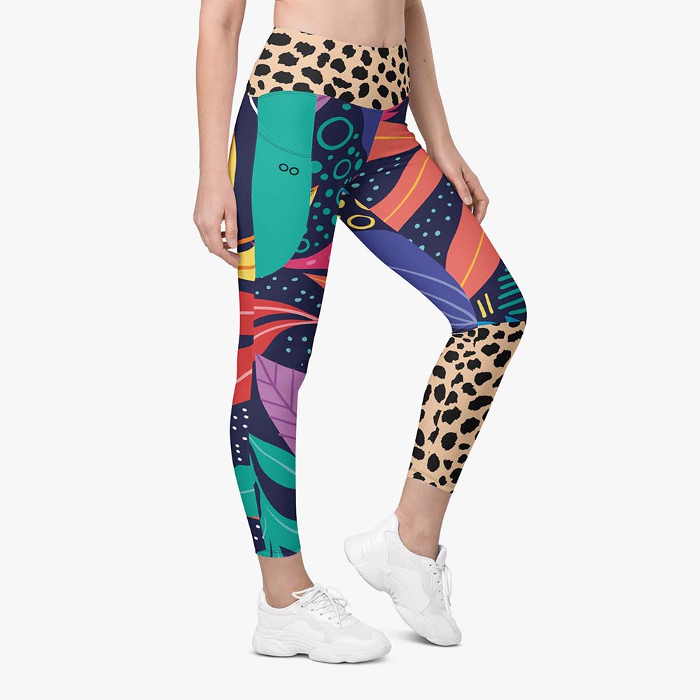 Front view of white leggings with pockets and abstract print.