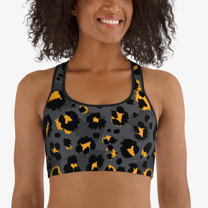 Close-up of black sports bra with abstract print, front view.