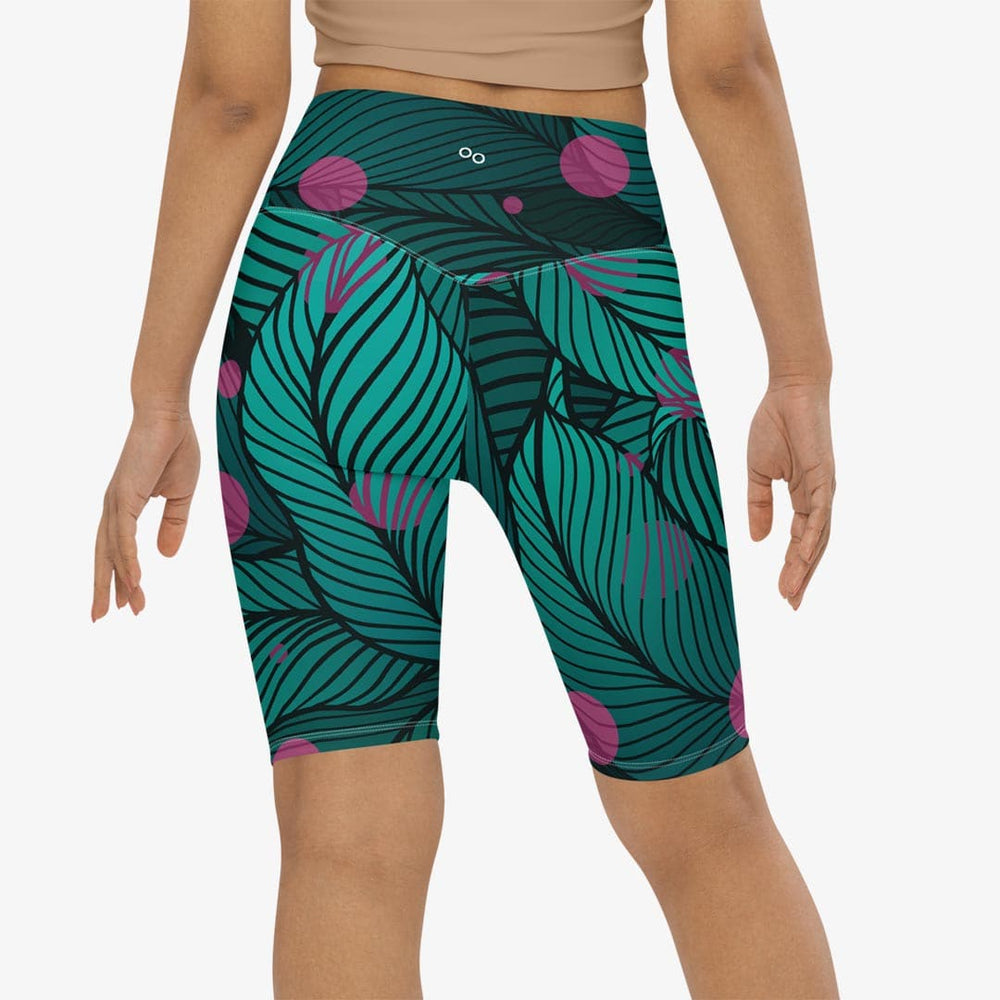 Green and pink biker shorts with abstract print on the back.